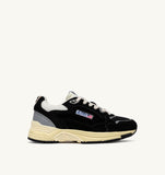 Profil droit des Autry Hyperway UM07 noires et blanc cassé, sneakers homme en mesh et daim, dispo à Versailles. seeyoustore