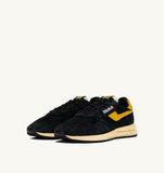 Sneakers Autry Reelwind noires et jaunes en mesh et daim, look rétro homme, dispo boutique Versailles