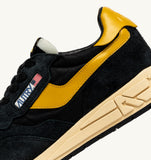 Sneakers Autry Reelwind noires et jaunes en mesh et daim, look rétro homme, dispo boutique Versailles