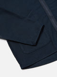Gros plan sur le tissu en coton slub sateen de la Zip Liner Jacket Universal Works. Une finition texturée subtile qui capte la lumière pour un rendu sophistiqué. Un mélange parfait entre robustesse et élégance. À découvrir en boutique chez SEE YOU à Versailles.