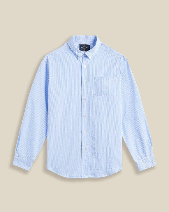 Chemise ATLANTICO à rayures bleu en seersucker – Portuguese Flannel. Coupe droite, tissu gaufré respirant, parfaite pour l'été. Disponible chez SEE YOU, concept store masculin à Versailles.