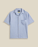 Chemise à manches courtes Jacquard rayé Chambray Portuguese Flannel – coupe droite, tissu chambray à rayures jacquard subtiles. Une pièce estivale élégante et légère, à découvrir chez SEE YOU, concept store à Versailles.