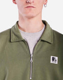 weat zippé Manso vert OLOW en coton bio, avec col montant et poches latérales. Style minimaliste et confortable, idéal pour un look casual écoresponsable.