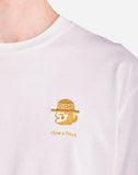 Focus sur l’imprimé Sabanero du T-shirt OLOW. Motif minimaliste discret sur la poitrine, imprimé avec une sérigraphie de haute qualité pour un rendu net et durable.